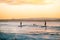 Silhouette of Surfers Riding a Wave at Sunset Time in Noosa,Queensland,Australia