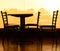 Silhouette table and chair in cafe at sunset