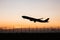 Silhouette takeoff plane while sunset