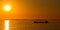 Silhouette tanker at anchor at sunset