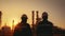 Silhouette of Teams engineer and foreman working at petrochemical oil refinery in sunset