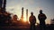 Silhouette of Teams engineer and foreman working at petrochemical oil refinery in sunset