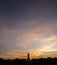 Silhouette technique under golden twilight evening sky with Walking Buddha statue in Thailand