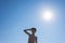 Silhouette of teen boy on the beach opposite sun.
