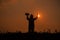 Silhouette of teen girls praying to god with the bible