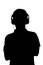 Silhouette of teenager listening to music in headphones, man folded his arms on the chest on white isolated background