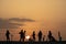 Silhouette of teenagers with their E-bikes during sunset