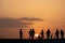 Silhouette of teenagers with their E-bikes during sunset