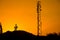 Silhouette of telecommunication antenna cellular tower for telephony with beautiful sunset