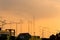 Silhouette, telecommunication towers with TV antennas and satellite dish in sunset. Many home TV antennas and satellite mounted