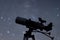 Silhouette of Telescope in real night sky. Blurred night sky. Blurred milky way.