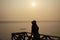 Silhouette thai women with long tail boat and reflection light surface water of Mekhong River and lighting of Sun in morning time