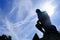 Silhouette Thinker Statue with Fare Light and Blue Sky Background in front of Rodin Museum, Paris France.