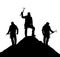 Silhouette of three climbers with ice axe in hand