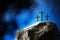 Silhouette of three crosses on Calvary hill, blue background. Crucifixion, resurrection of Jesus Christ. Christian