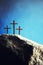 Silhouette of three crosses on Calvary hill, blue background. Crucifixion, resurrection of Jesus Christ. Christian