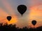 Silhouette of three hot air balloons at dawn