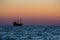 A silhouette of a three mast sailing ship as it heads out into the Gulf.