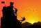 Silhouette of three men climbing mountain by helping each other on sunrise background, successful teamwork concept