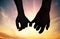 Silhouette of touching hands in sunset. Love concept