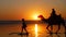 Silhouette of tourist on camel ride convoy