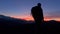 silhouette of tourist hiker man with backpack at sunset