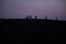 Silhouette tourists on Etna Volcano at sunset light