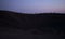 Silhouette tourists on Etna Volcano at sunset light