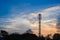 Silhouette of Tower antenna transmission. Repeater of communication and telecommunication with beautiful cloudy sky at sunset on