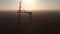 Silhouette of tower crane installing blade to wind turbine