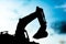 silhouette tracked excavator Sand and stone And sky background