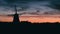 Silhouette of traditional Dutch windmill at sunset at sunset