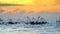 Silhouette of traditional fishing method using a bamboo square dip net with sunrise sky background