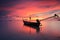 Silhouette traditional longtail boat and beautiful red sky and s