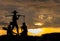 Silhouette of Traditional Thai Farmer Carry The Baskets of Rice in His Hand with Women on The Floor at The Corner. Labor Day