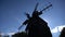 Silhouette of a traditional windmill against sky