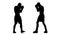 Silhouette. Training between two sportsmen boxers men. Slow motion