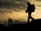 Silhouette traveller with camera and the couple on the rock at s