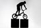 silhouette of trial biker balancing on two stands
