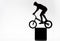 silhouette of trial cyclist balancing on cube