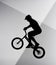 silhouette of trial cyclist jumping on bicycle on abstract grey