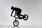 silhouette of trial cyclist performing front wheel stand