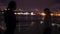 Silhouette of two beautiful young women dancing on ship deck at night. Girlfriends on the boat