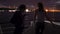 Silhouette of two beautiful young women dancing on ship deck at night. Girlfriends on the boat