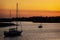 A silhouette of two boats against an orange sky in South Carolina.