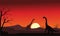 Silhouette of two brachiosaurus at sunset