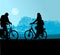 Silhouette of two cyclists in opposite directions through a moonlit landscape with blue colors