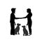 Silhouette of two dog owners training their pets to sit close behave when meeting greeting each other