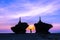 Silhouette of two golden pagodas on top of rocks on Ngwesaung beach, west coast of Myanmar