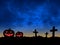 silhouette two jack o lantern pumpkin and three cross on cemetery with colorful stormy motion on dramatic sky
